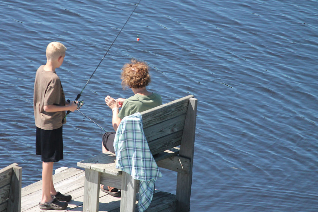 Mother and son fishing from the dock